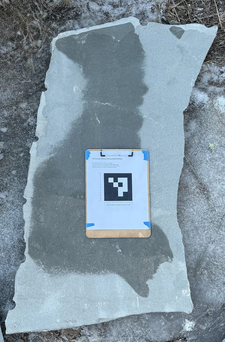 Irregular patio stones photographed with the Hardscape Genius measurement marker
